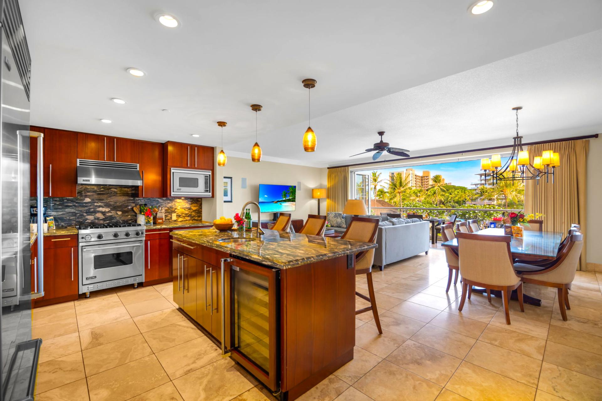 Fully equipped kitchen with stainless appliances and breakfast bar opens to the living space. HKH-203