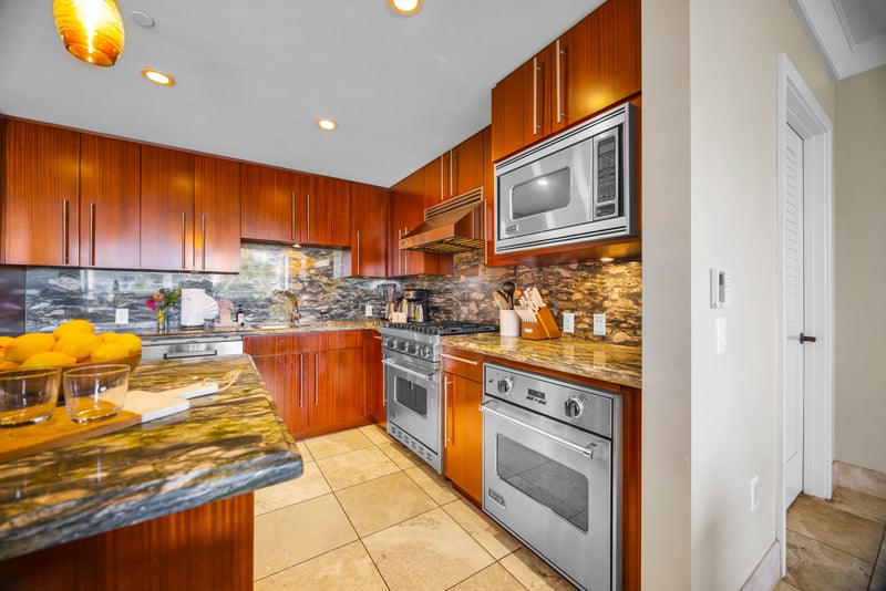 Modern kitchen design with gas range and sleek finishes adds both style and function.