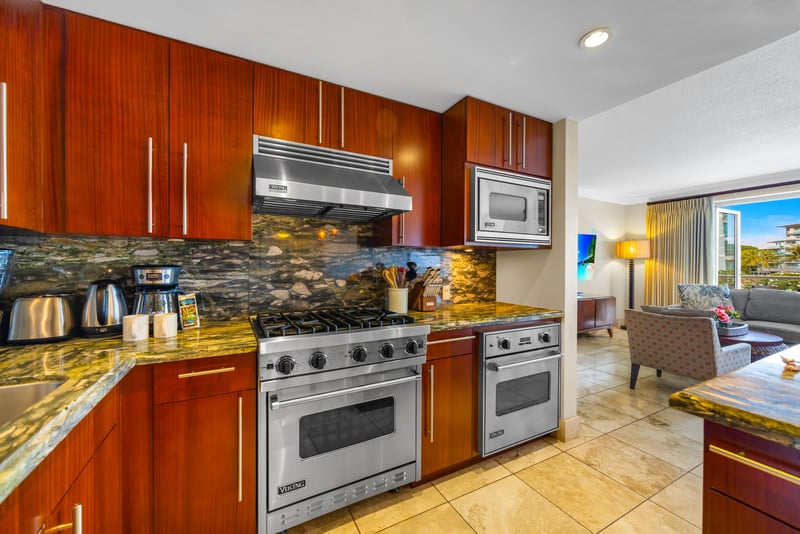 Stainless steel gas range and granite counters for effortless at-home cooking.