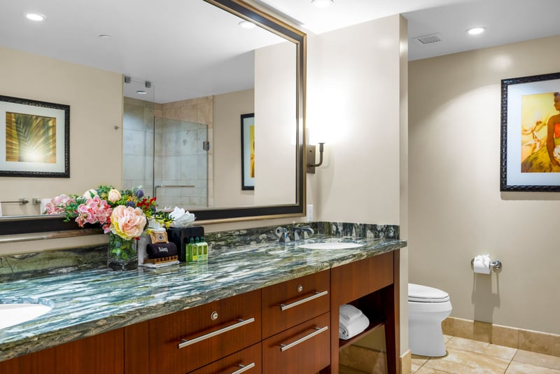Your spacious primary bath features a granite dual vanity, walk-in shower, and soaking tub stocked with L’Occitane amenities.