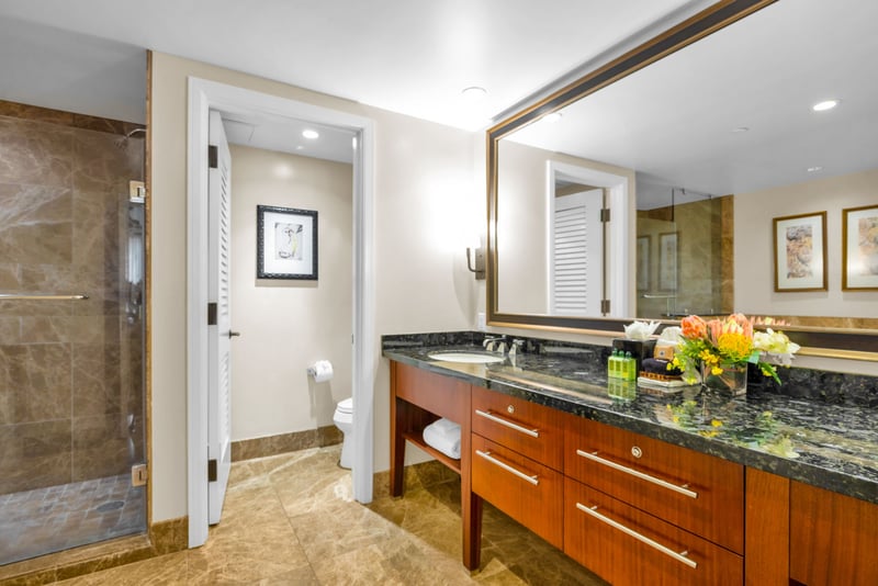 This guest bathroom connects conveniently to the hall, with generous counter space and warm lighting.
