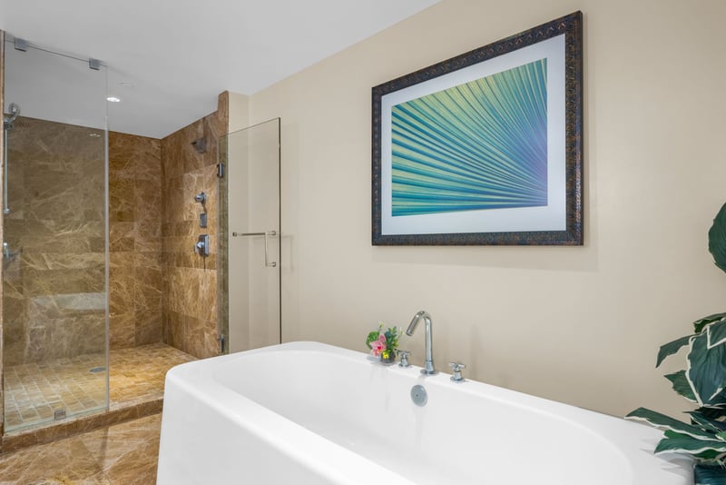 Soak the day away in your full tub surrounded by natural stone tile and spa-style details.