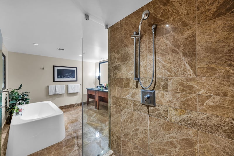 This bathroom includes a walk-in shower, soaking tub, and spacious layout for added privacy and ease.