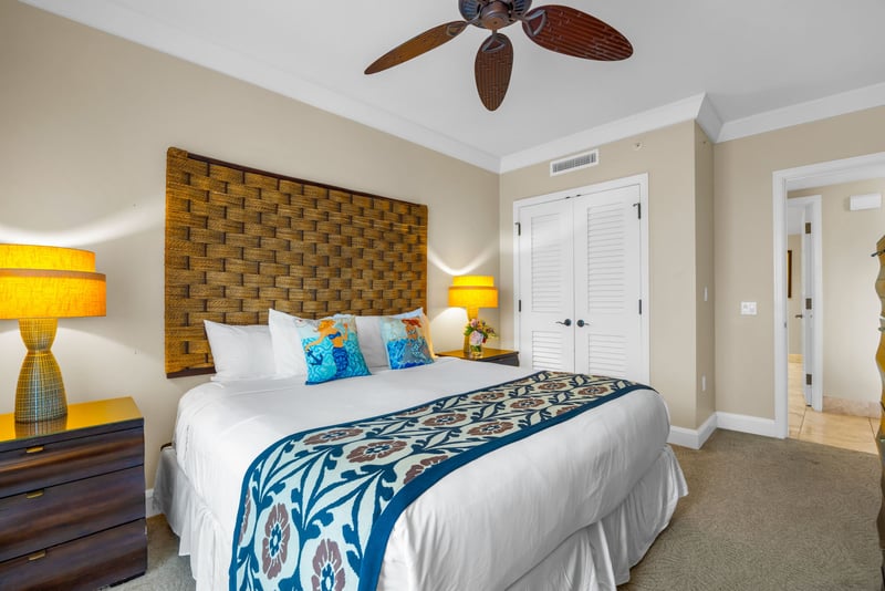 King bed and soft lighting set a peaceful tone in the primary bedroom with ensuite bath.