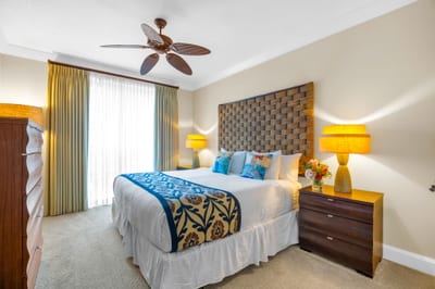 Primary bedroom with a King bed, textured headboard, and calming tones for a luxurious retreat.