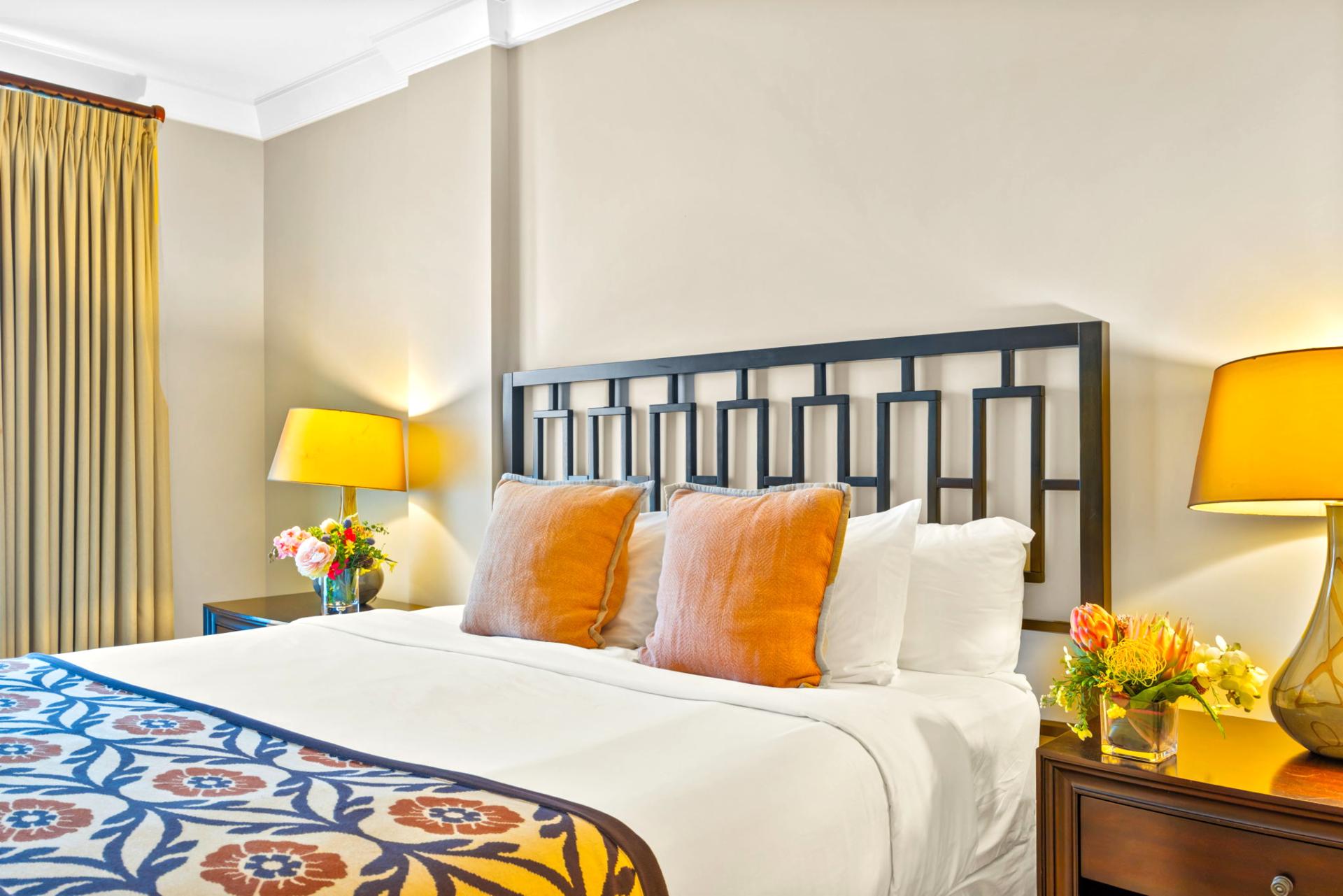 This guest room offers a bright and inviting space with cheerful decor and a Queen bed for restful sleep. HKH-203