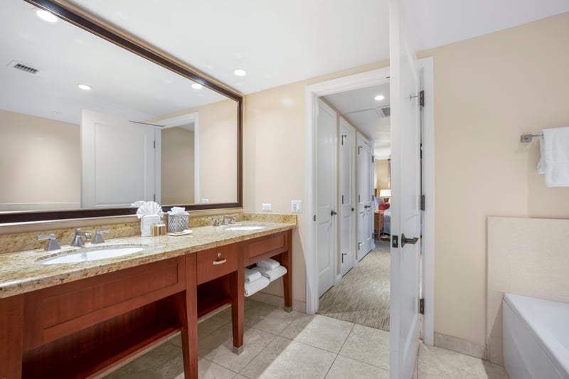 Luxury bathroom retreat with granite vanity and suite-style access.