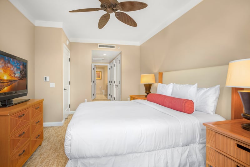 Bright island bedroom with tropical charm and modern suite amenities.