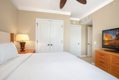 Relaxing bedroom with tropical charm, warm lighting, and double closets. HKH-222