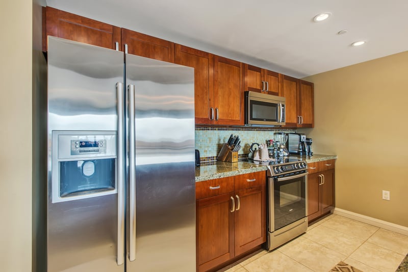 Stylish kitchen with rich cabinetry and stainless steel appliances