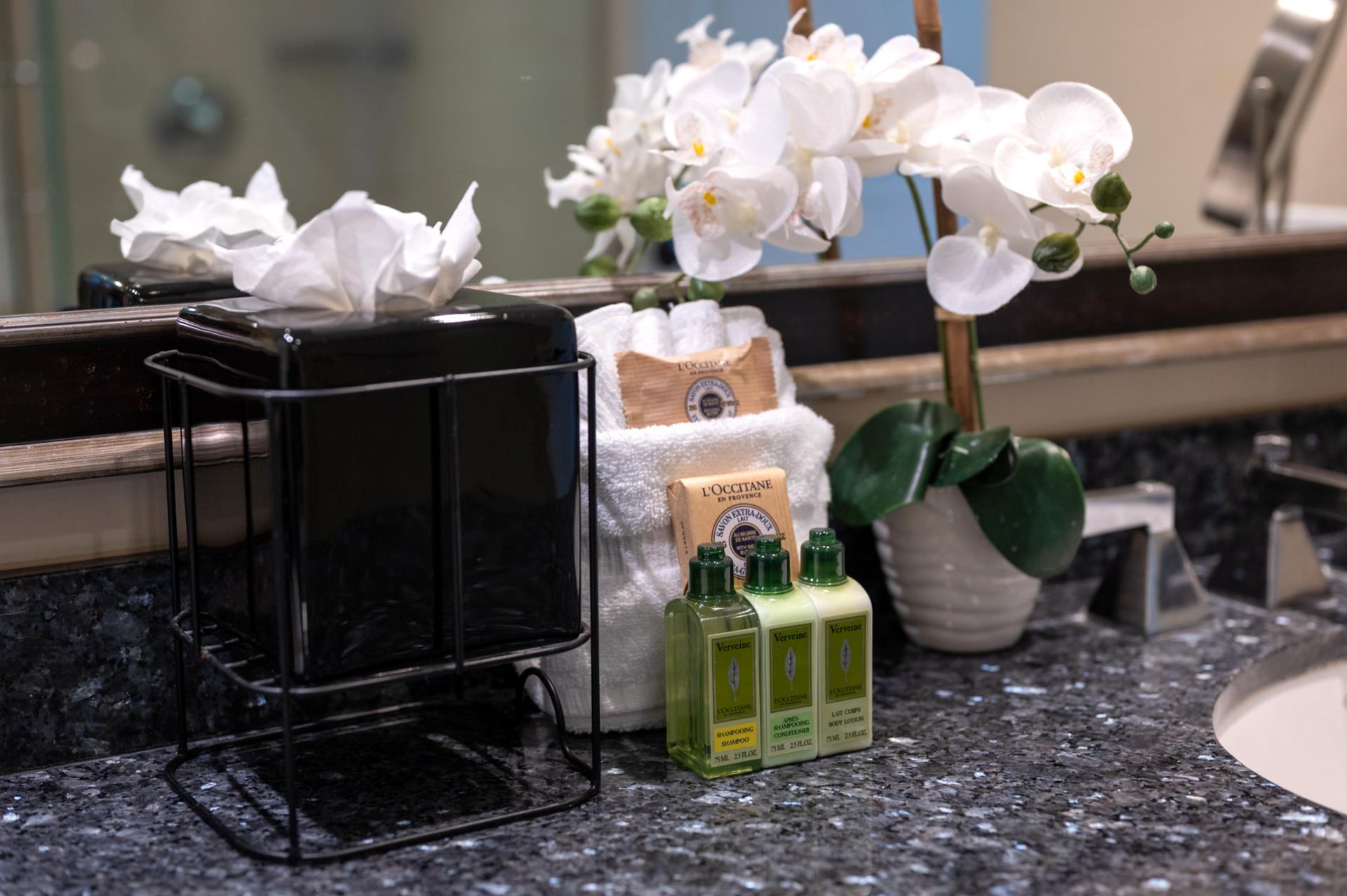 L’Occitane amenities and soft towels offer a touch of spa luxury in the bathroom.