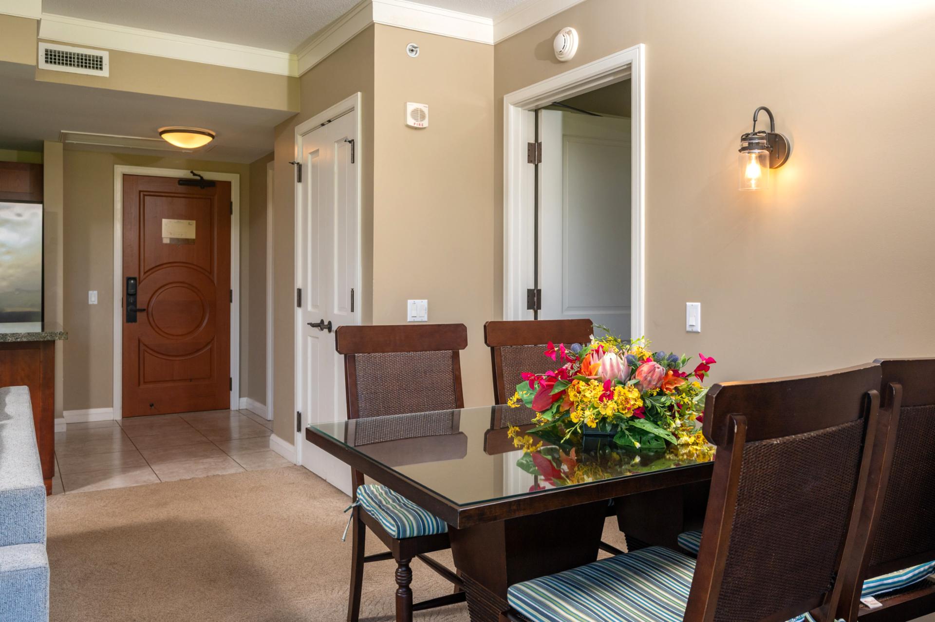 Entryway opens to a warm dining area with easy access to both the kitchen and living room.