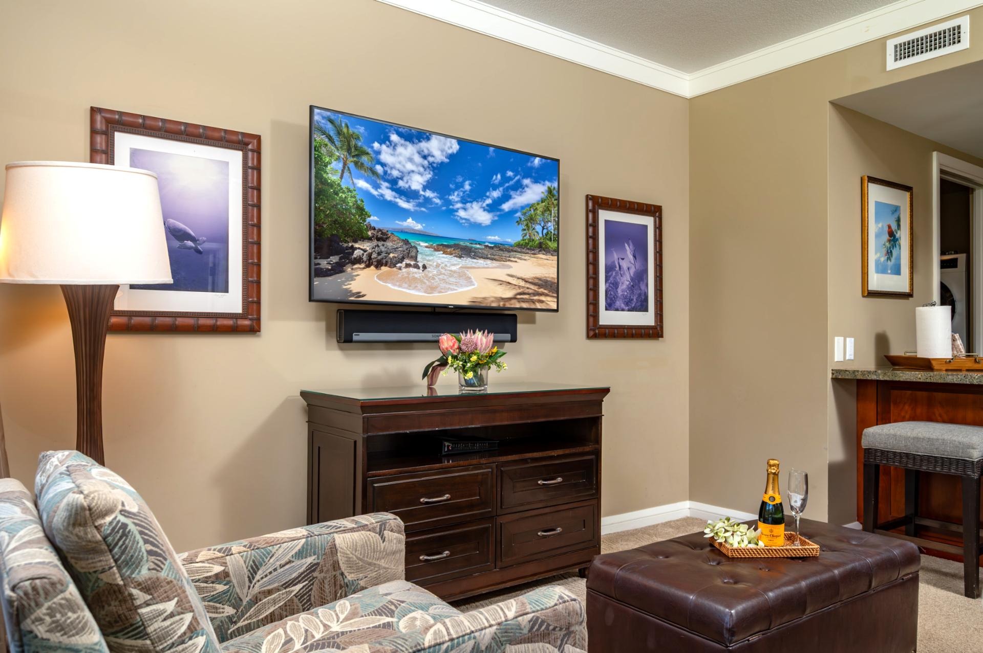 Cozy seating area with Smart TV and tropical artwork, ideal for evening downtime.