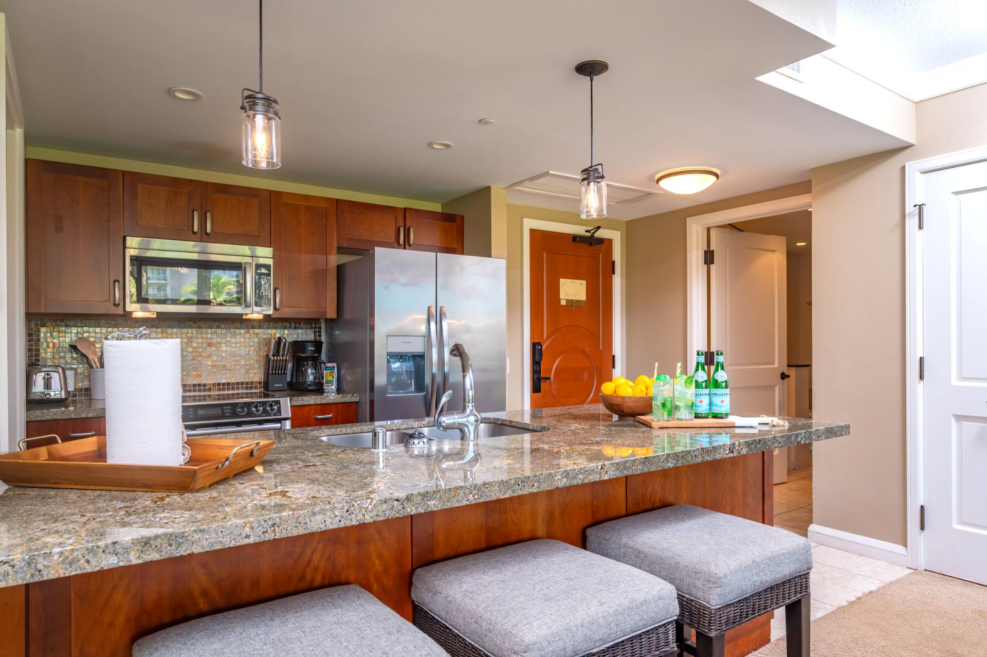 Fully equipped kitchen with bar seating and pendant lighting for both style and function.