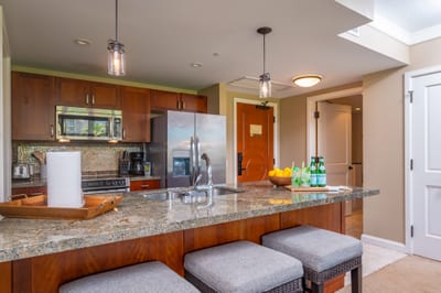 Fully equipped kitchen with bar seating and pendant lighting for both style and function.