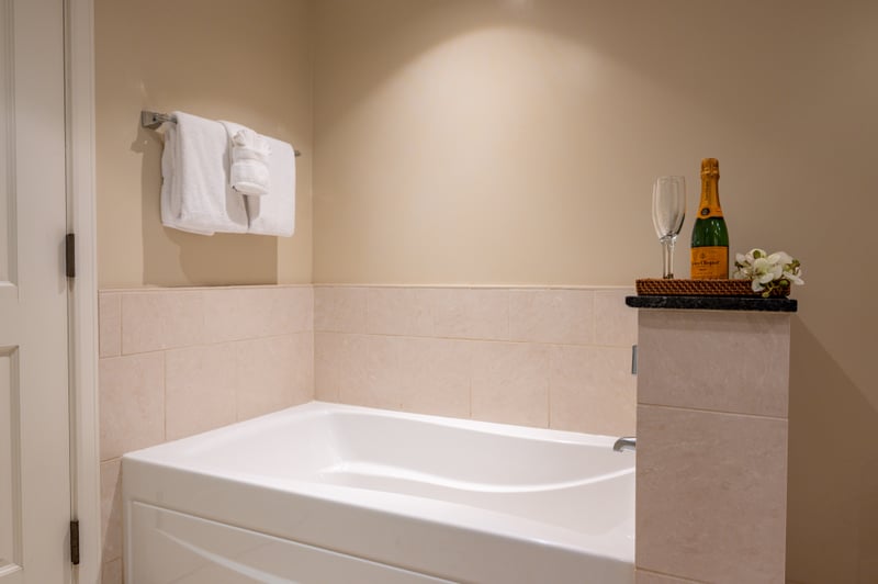 Separate soaking tub with sleek granite counters brings a luxe feel to your ensuite bath.