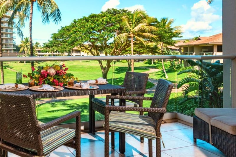 Private lanai with lush garden views and a dining table perfect for morning coffee or open-air meals.