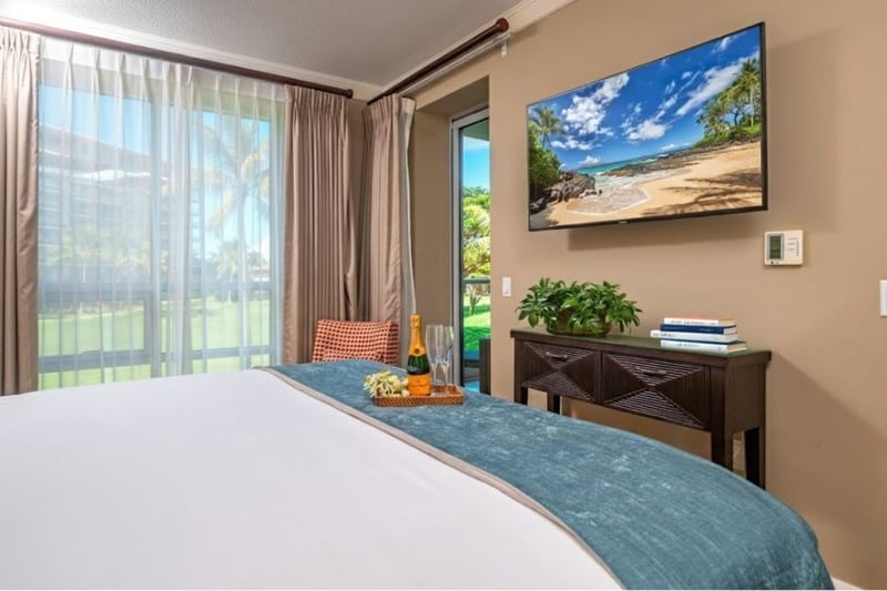 King bedroom with Smart TV and ceiling fan, offering both comfort and entertainment. HKH-240