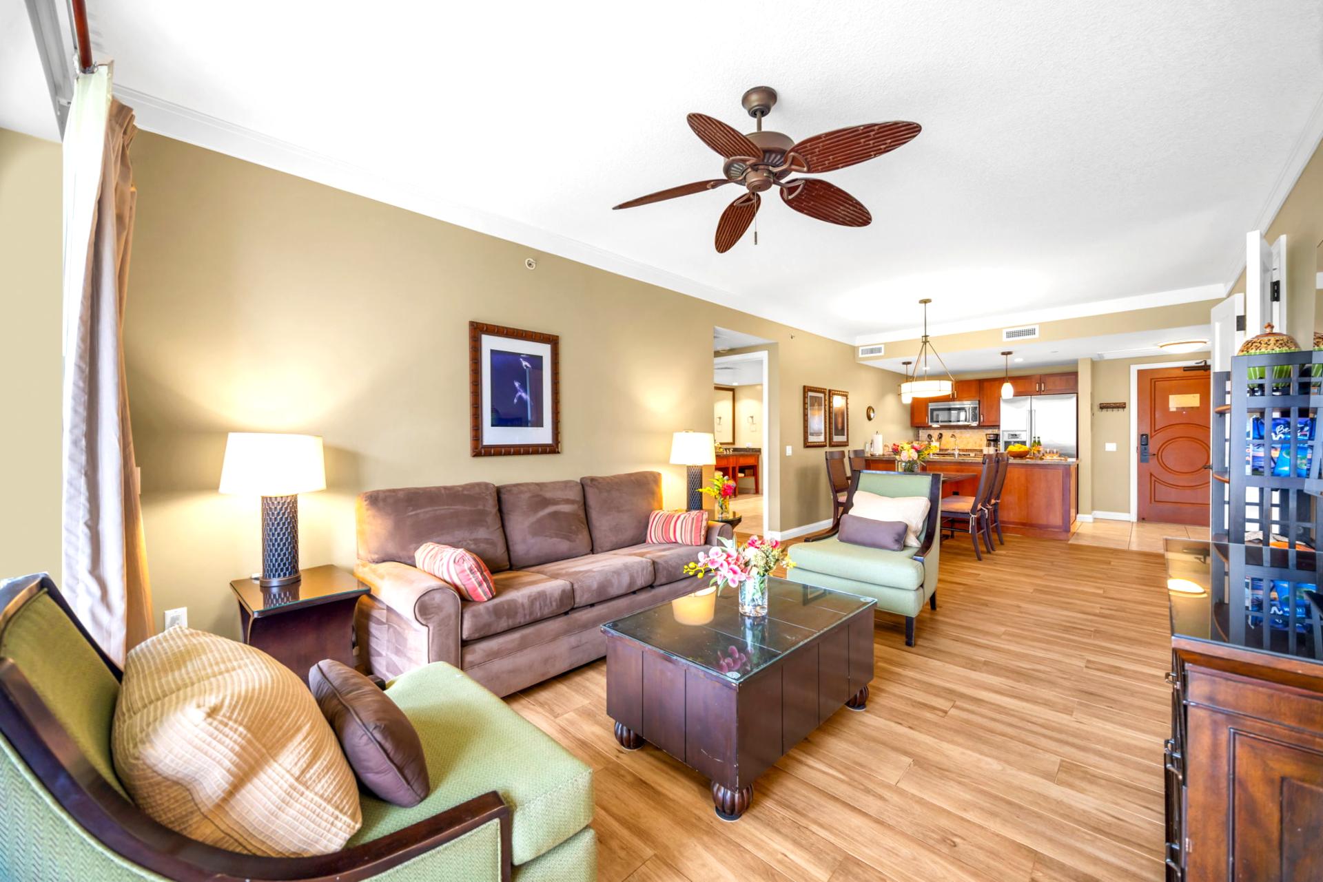 Gather in the open living area with warm wood tones, ample seating, and direct access to outdoor space.