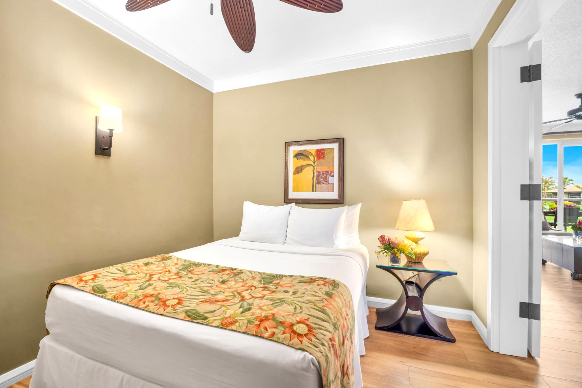 The second bedroom features a Queen bed and warm wood décor, with easy access to the shared bathroom.