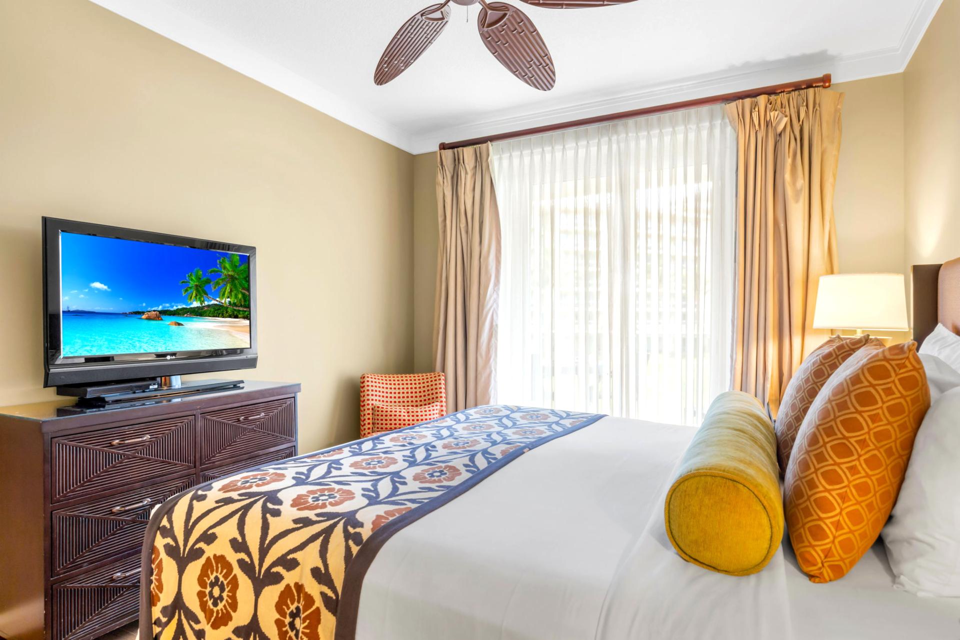 Wake to garden views in the primary bedroom, complete with a King bed and sliding doors to the lanai.