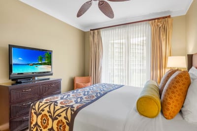 Wake to garden views in the primary bedroom, complete with a King bed and sliding doors to the lanai.