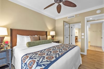 Your primary suite opens to the lanai and features resort views, a King bed, and soothing neutral tones.