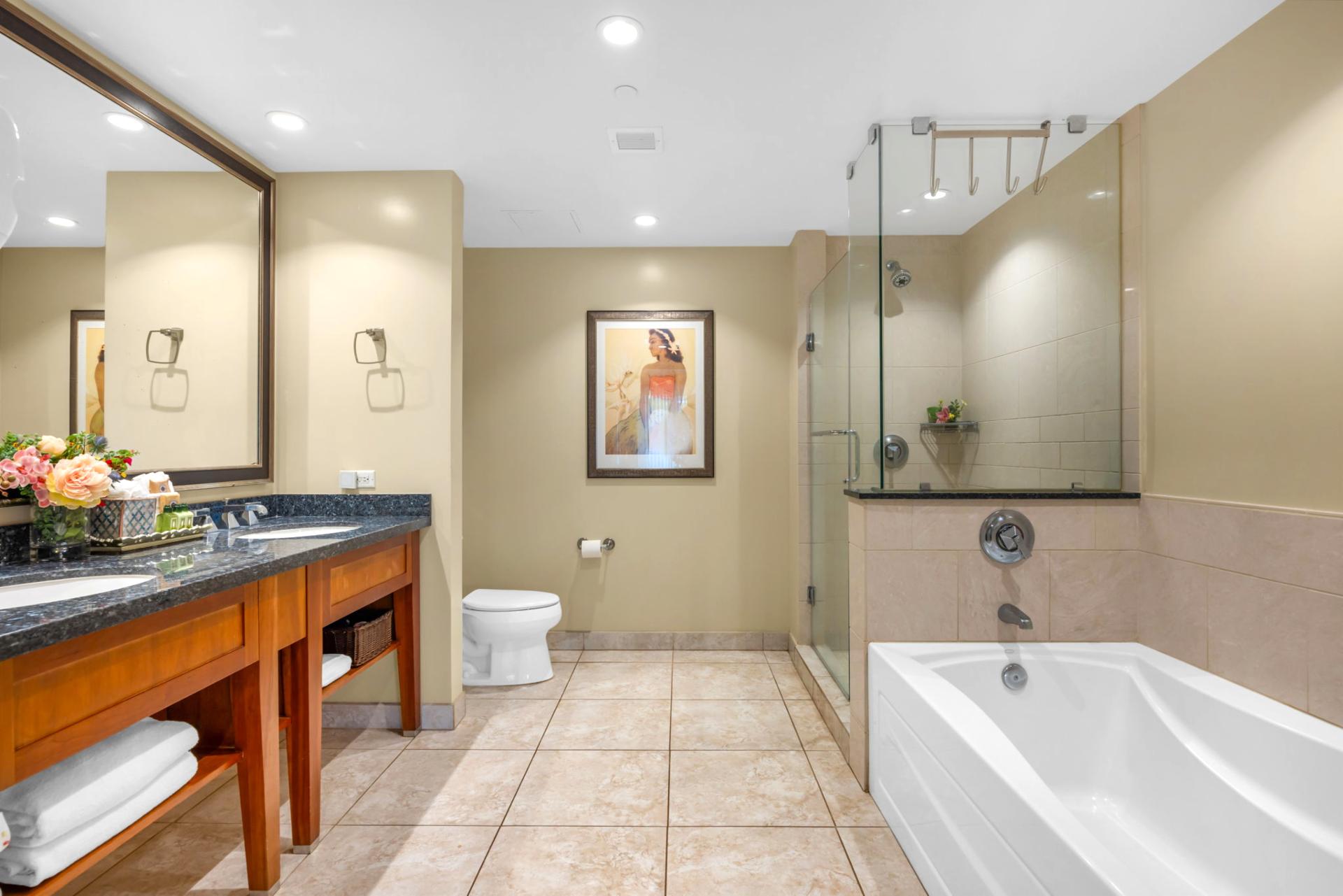 The en suite bath includes a granite vanity and walk-in shower with glass door for a refreshing daily routine.
