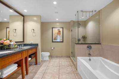 The en suite bath includes a granite vanity and walk-in shower with glass door for a refreshing daily routine.