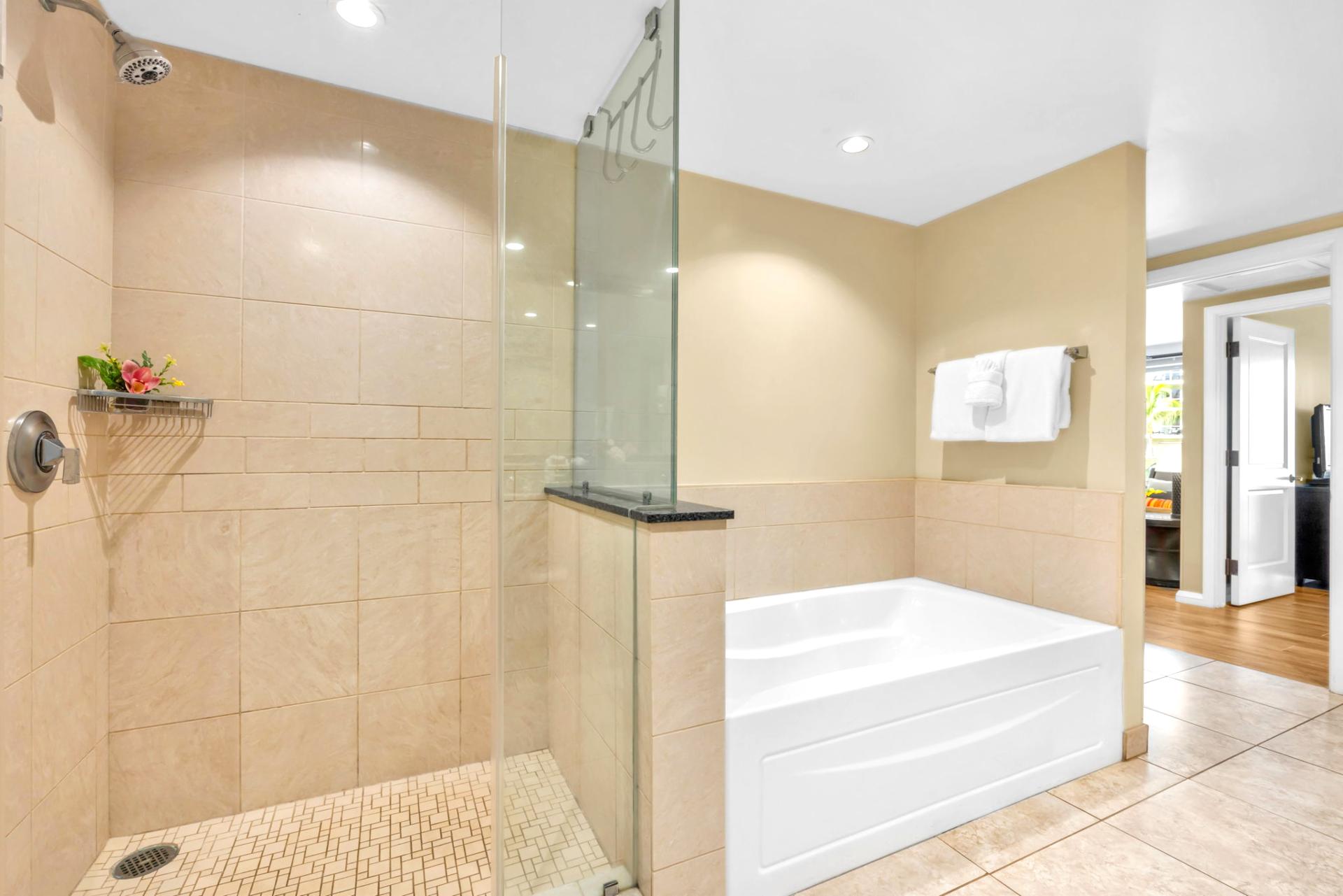 The en suite bath includes a granite vanity and walk-in shower with glass door for a refreshing daily routine.