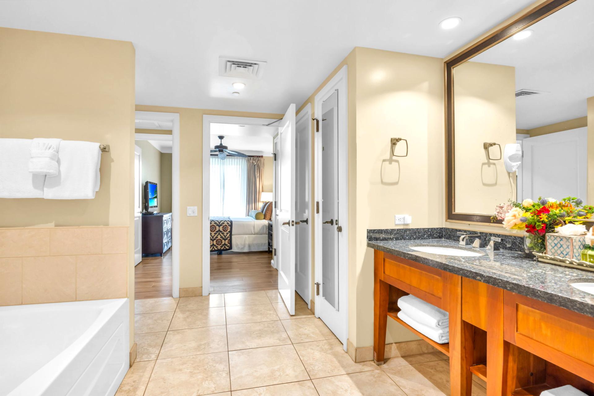 The en suite bath includes a granite vanity and walk-in shower with glass door for a refreshing daily routine.