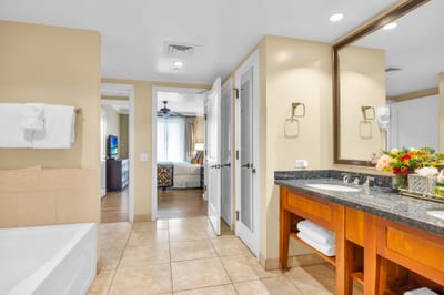 The en suite bath includes a granite vanity and walk-in shower with glass door for a refreshing daily routine.