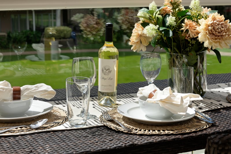 Experience alfresco dining with sweeping views of manicured lawns and palms