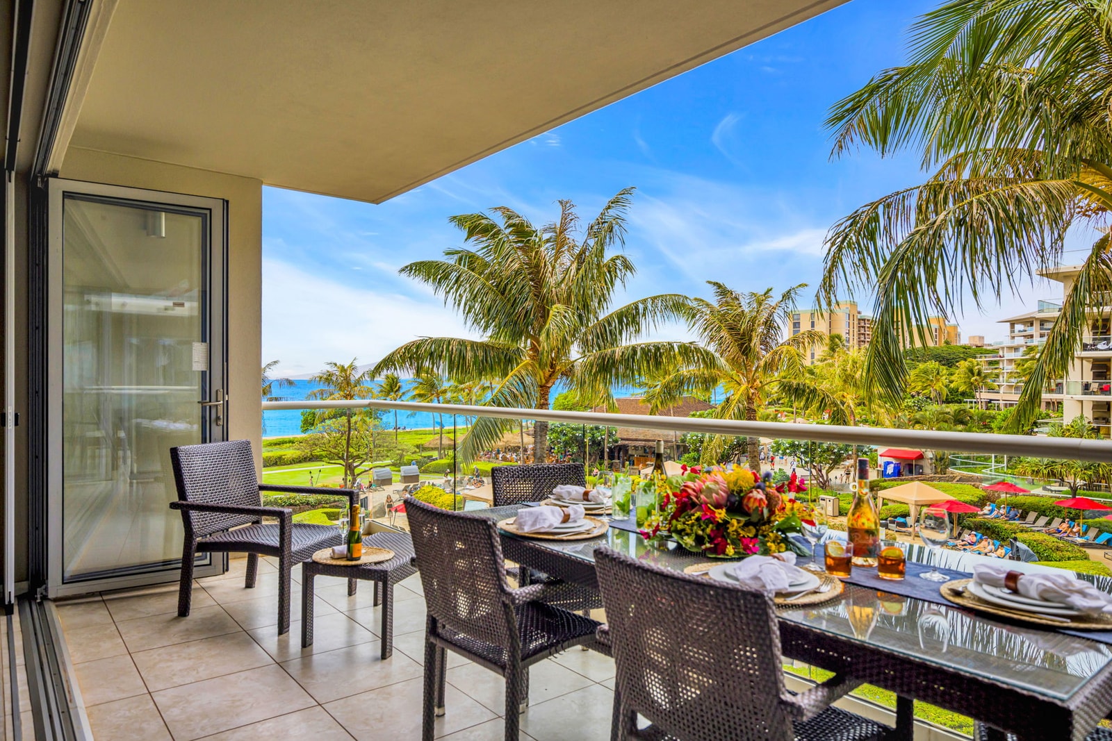 Spacious lanai with full dining setup and lush garden views invites easy outdoor meals. HKH-305