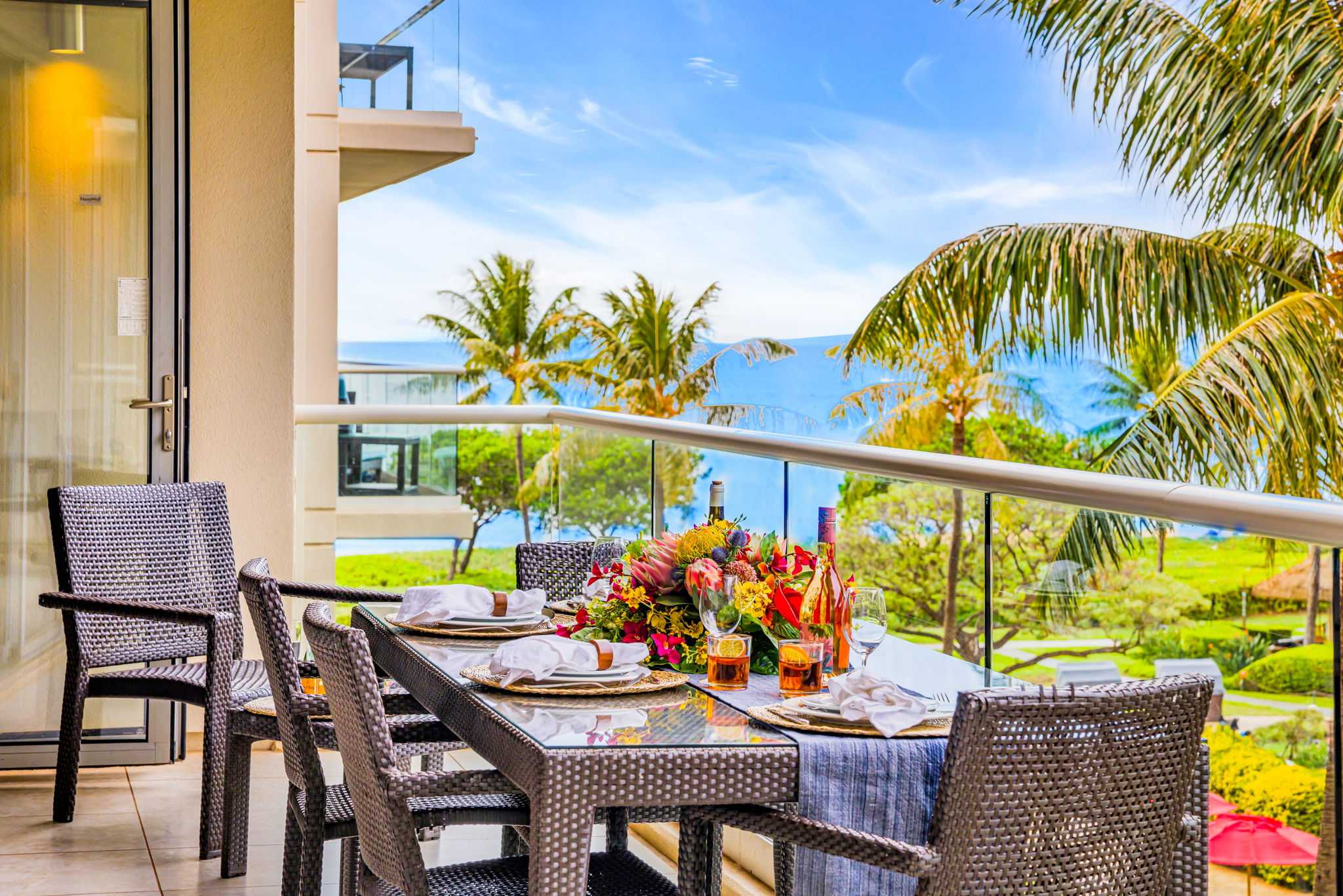 Ocean-view lanai with a dining set and lounge chairs, perfect for al fresco meals or unwinding in the island breeze. HKH-305