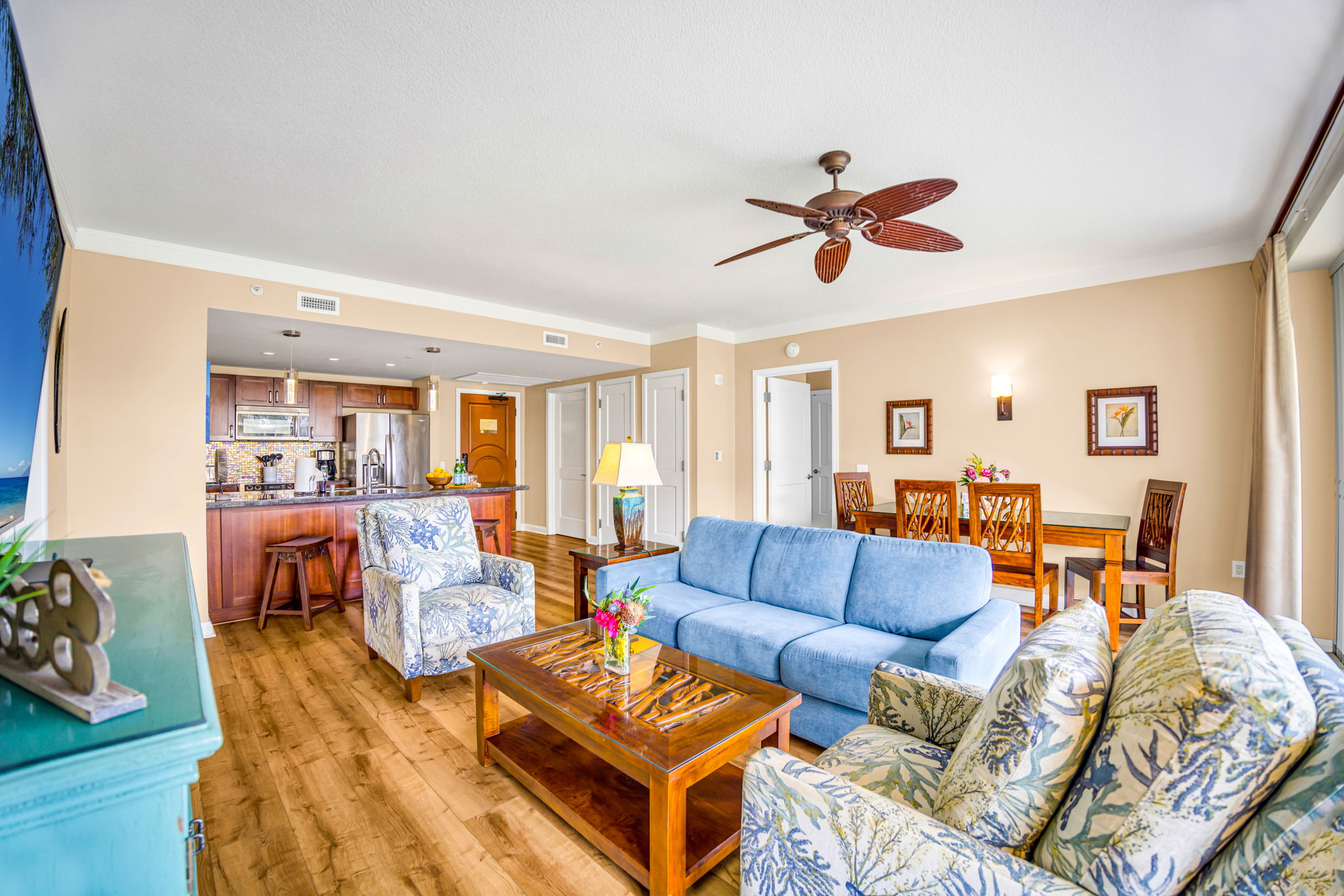 Spacious living room blends comfort and function with ample seating and tropical-themed design. HKH-305