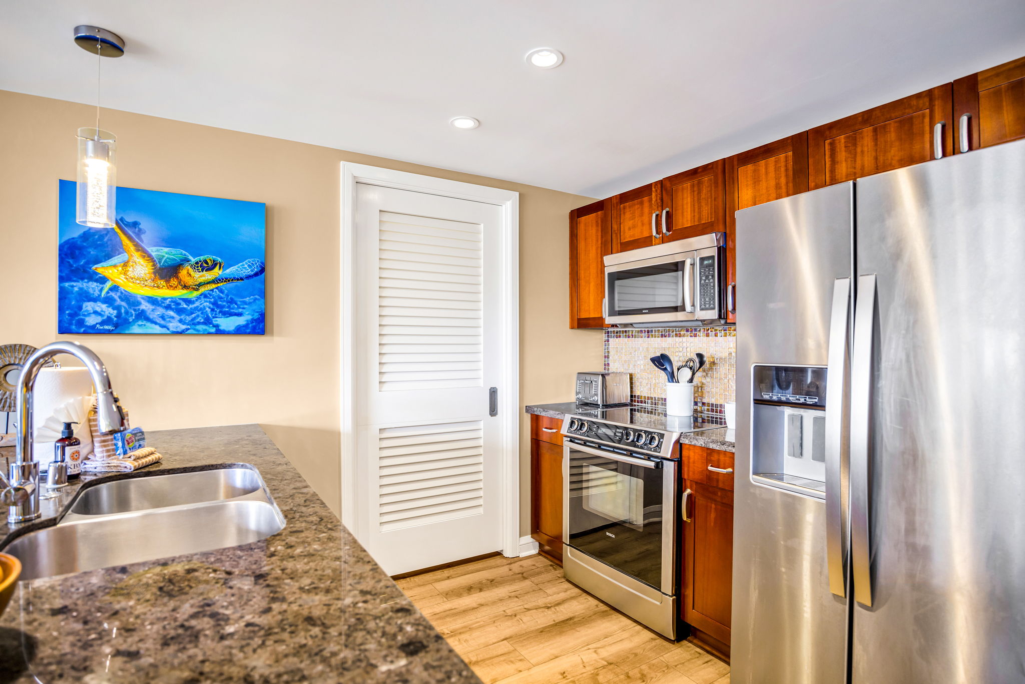 Side-by-side fridge, granite counters, and full-size appliances in a kitchen that makes dining in a breeze. HKH-305