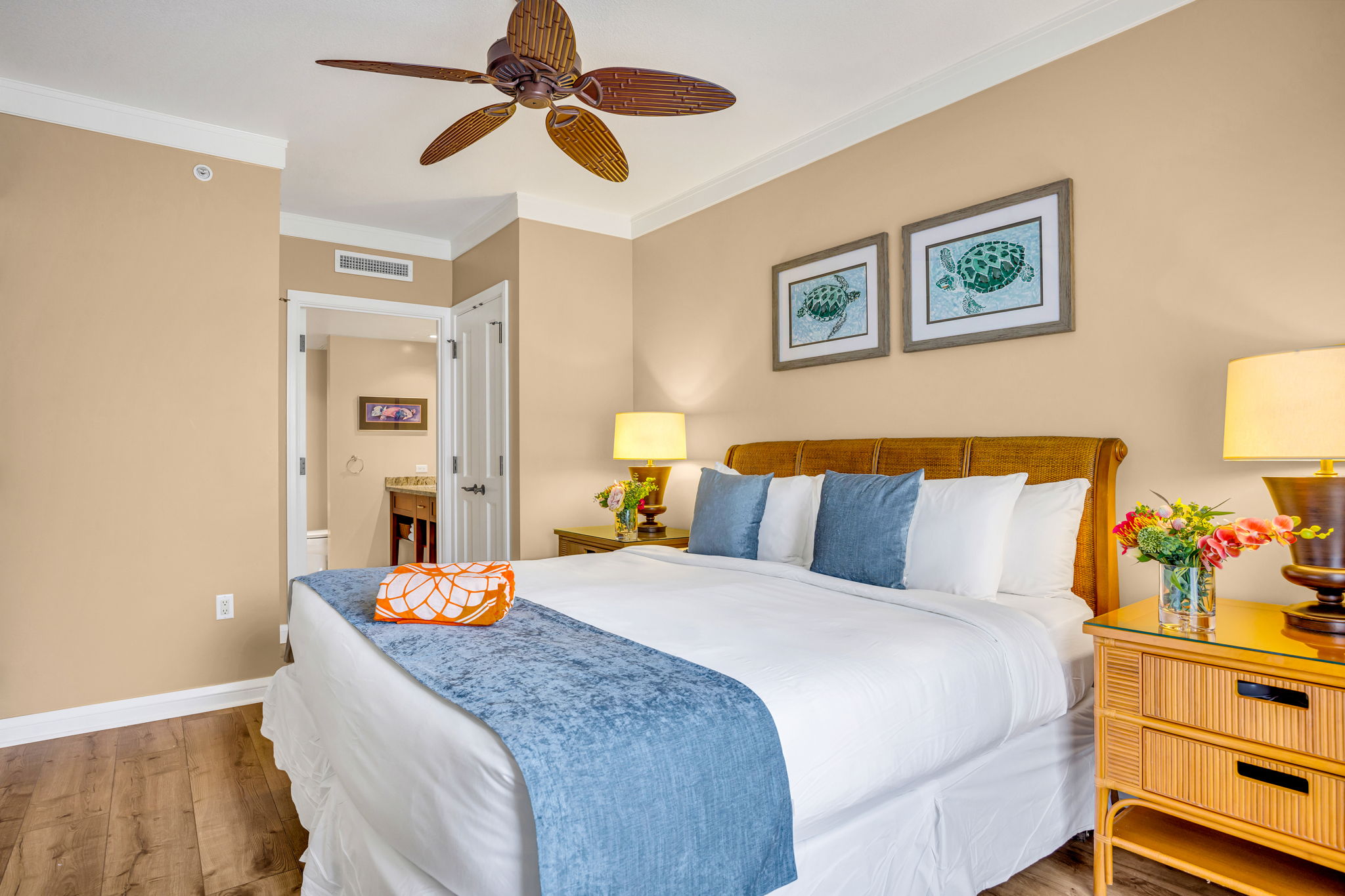 Spacious King bedroom with coastal accents and a ceiling fan for restful nights. HKH-305