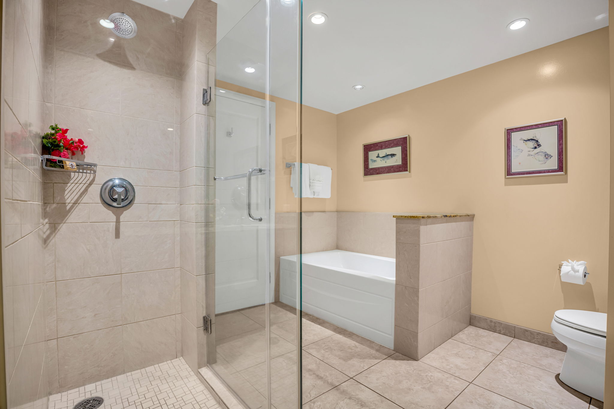 Glass walk-in shower and spa-style finishes in the beautifully appointed primary bath. HKH-305