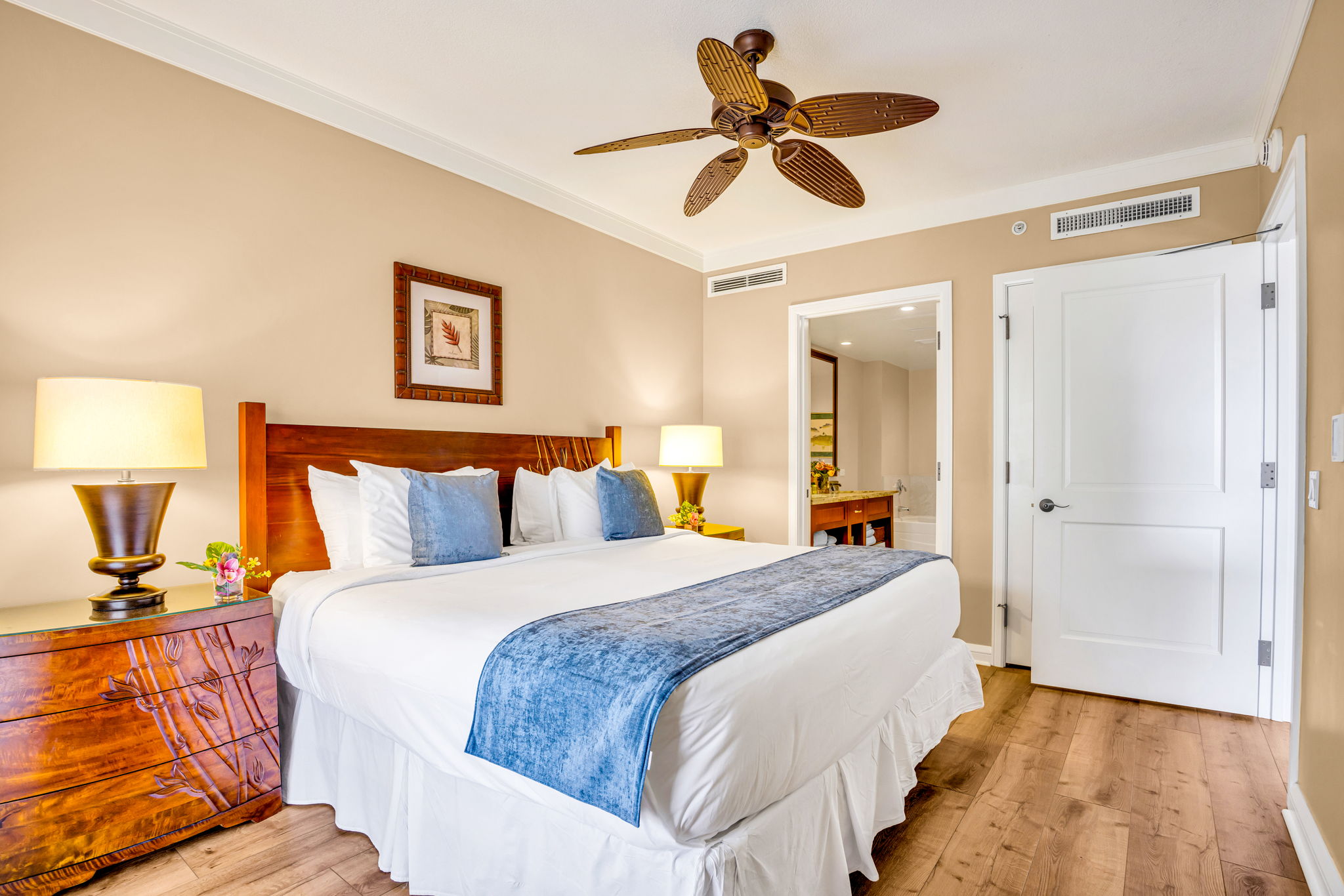 Guest bedroom with King bed and ceiling fan offers privacy and comfort for friends or family. HKH-305