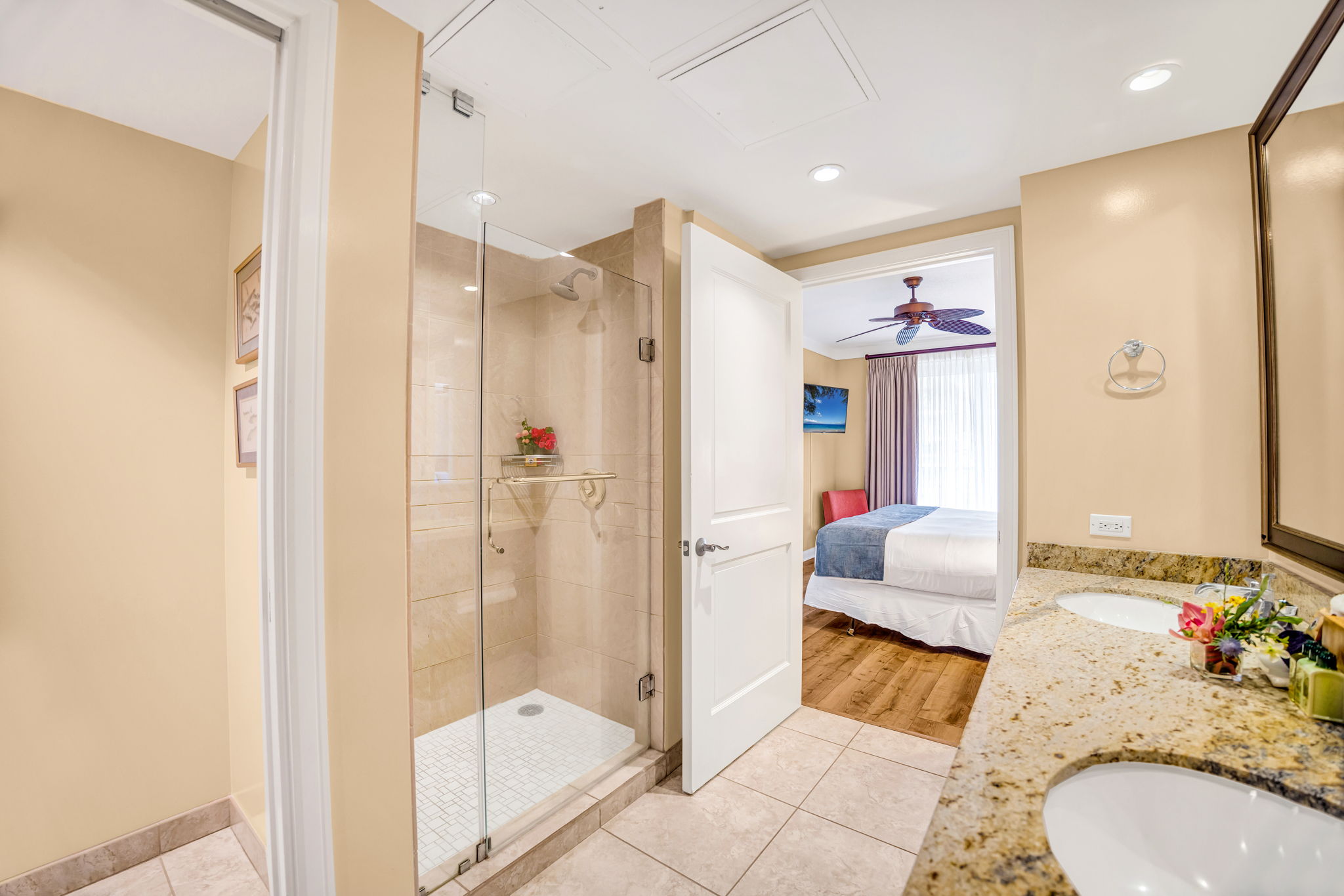 Guest bath with walk-in shower and modern tile, located near the second bedroom for added convenience.