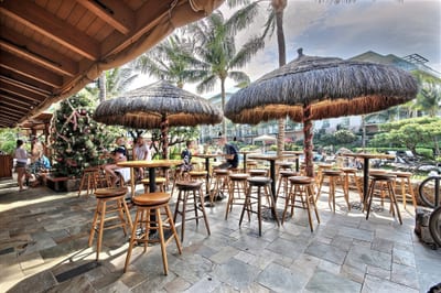 Resort-style tiki bar with thatched umbrellas, outdoor seating, and tropical drinks just steps from your suite.
