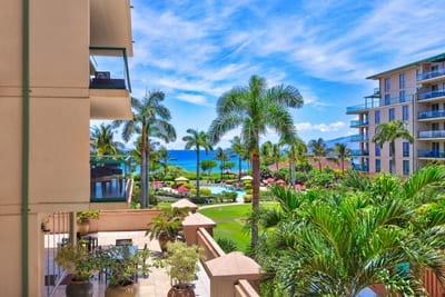 Panoramic ocean and pool views from your balcony overlooking tropical gardens and shimmering water features