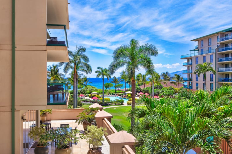 Panoramic ocean and pool views from your balcony overlooking tropical gardens and shimmering water features