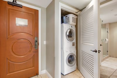 Convenient in-unit laundry with storage shelves and full-size appliances for extended comfort