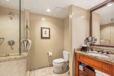 Luxury bathroom with granite vanity, glass walk-in shower, and resort-style finishes for your comfort
