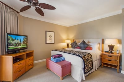 Wake up to garden views in this bright, well-appointed bedroom with TV, plush bedding, and private balcony