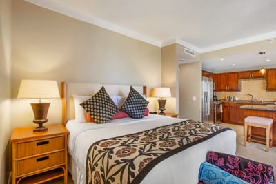 Comfort meets scenery in this king bedroom with flat-screen TV, island decor, and open-air balcony access