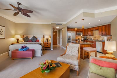Bright island-style living room with plush seating, tropical views, and direct lanai access for ocean breezes