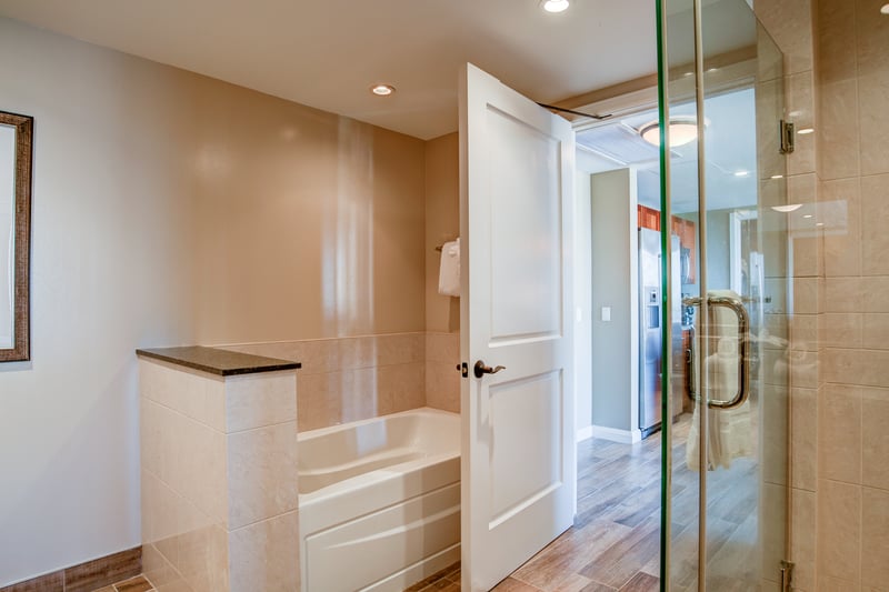 Refresh in a sleek walk-in shower with high-end finishes—your private oasis after tropical island adventures
